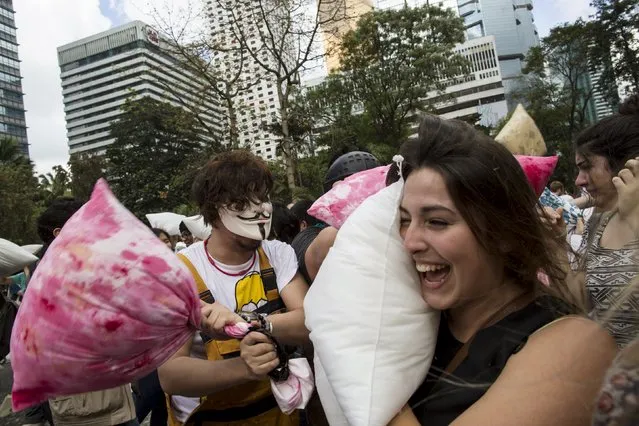People take part in the International Pillow Fight Day at Hong Kong's financial Central district April 4, 2015. (Photo by Tyrone Siu/Reuters)