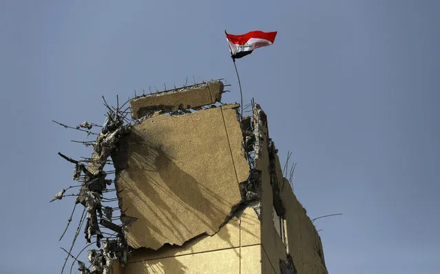 An Iraqi flag waves over the damaged building of al-Salam hospital in Mosul, Iraq, Tuesday, January 10, 2017. The Mosul hospital has been left almost completely gutted by the battle to retake it. Al-Salam hospital was the scene of one of the most significant setbacks for Iraqi troops in the Mosul operation, but was retaken this month after a stepped-up campaign of US-led coalition airstrikes, despite the coalition’s initial reluctance to use airstrikes against IS there. (Photo by Khalid Mohammed/AP Photo)