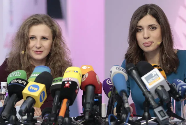 Russian punk band p*ssy Riot members Nadezhda Tolokonnikova, right, and Maria Alekhina smile during their news conference in Moscow, Russia, on Friday, December 27, 2013. Tolokonnikova and Alekhina were granted amnesty on Monday, December 23, two months short of their scheduled release after spending nearly two years in prison for their protest at Moscow's main cathedral. (Photo by Ivan Sekretarev/AP Photo)