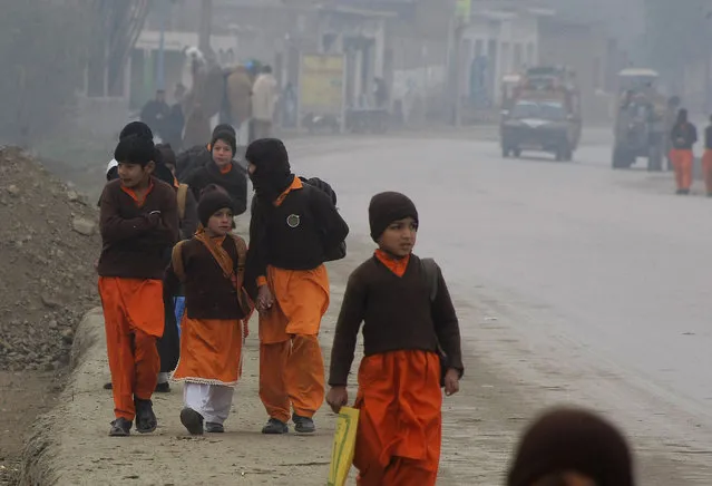 Pakistani students on their way to school in Charsadda, Pakistan where militants attacked the Bacha Khan University killing many students and others, Monday, January 25, 2016. Officials say a northwestern Pakistani university where Islamic militants gunned down 21 students and teachers last week has reopened for classes amid tight security. (Photo by Mohammad Sajjad/AP Photo)