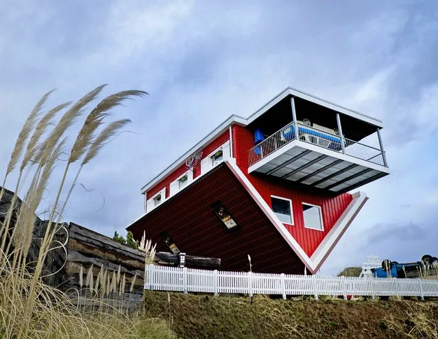 An upside down house, open to the public as a tourist attraction, stands on a hill near the highway in Wertheim, southern Germany, Monday, March 4, 2019. (Photo by Michael Probst/AP Photo)