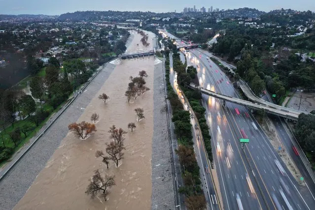 An aerial view of the Los Angeles River swollen by storm runoff as a powerful long-duration atmospheric river storm, the second in less than a week, continues to impact Southern California on February 5, 2024 in Los Angeles, California. Nearly seven inches of rain have fallen in downtown Los Angeles during the storm, about half the average yearly total. The storm is delivering widespread flooding, landslides and power outages while dropping heavy rain and snow across the region. (Photo by Mario Tama/Getty Images)
