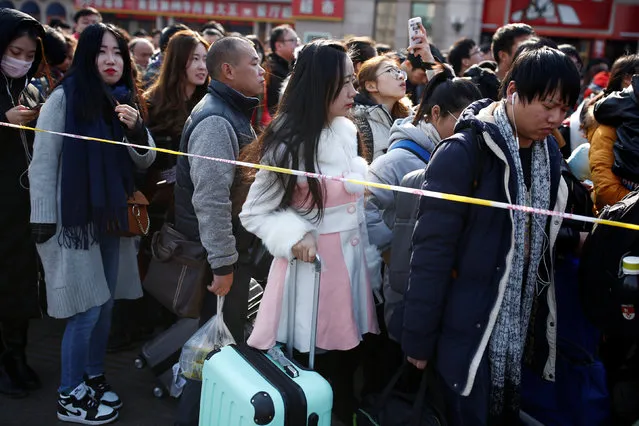 People line up at the subway station outside Beijing Railway Station on the last day of Chinese Lunar New Year holidays in Beijing, China, February 2, 2017. (Photo by Thomas Peter/Reuters)