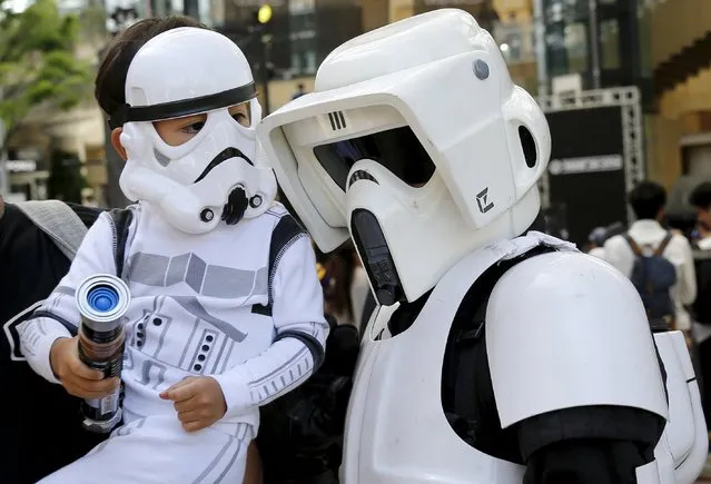 Cosplayers dressed up as Star Wars characters Scout Trooper (R) and Storm Trooper take part in a Star Wars Day fan event in Tokyo May 4, 2015. (Photo by Toru Hanai/Reuters)