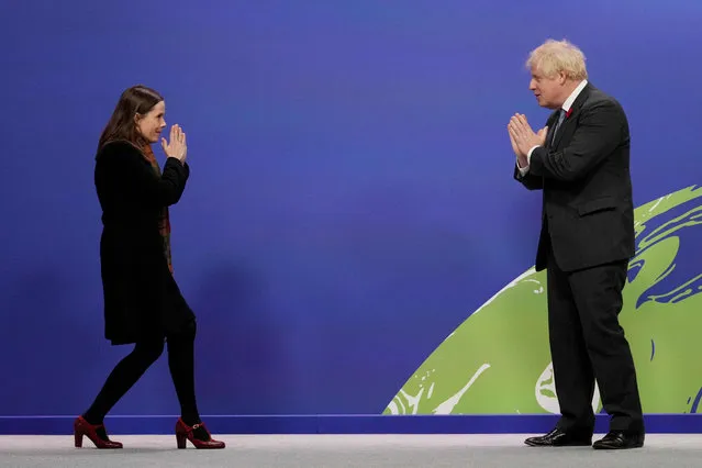Britain's Prime Minister Boris Johnson greets Iceland's Prime Minister Katrin Jakobsdottir as they arrive to attend the COP26 UN Climate Change Conference in Glasgow, Scotland on November 1, 2021. COP26, running from October 31 to November 12 in Glasgow will be the biggest climate conference since the 2015 Paris summit and is seen as crucial in setting worldwide emission targets to slow global warming, as well as firming up other key commitments. (Photo by Christopher Furlong/AFP Photo)