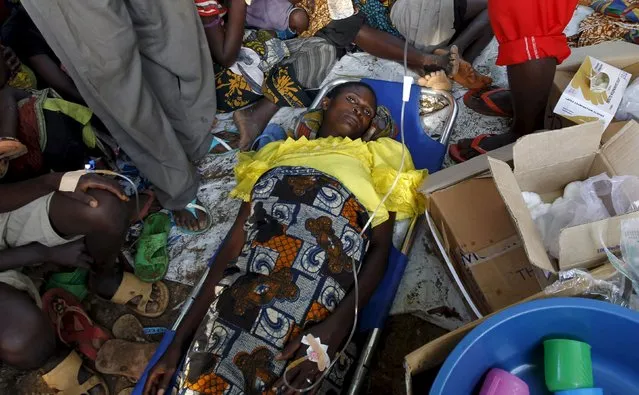 A sick Burundian refugee waits for treatment at a makeshift clinic on the shores of Lake Tanganyika in Kagunga village in Kigoma region in western Tanzania, as they wait for MV Liemba to transport them to Kigoma township, May 17, 2015. (Photo by Thomas Mukoya/Reuters)