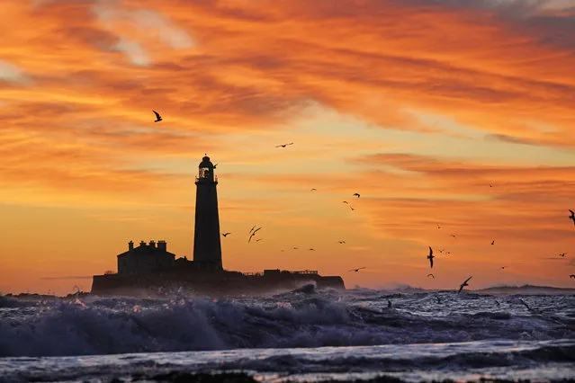 Waves crashing on the shore at sunrise at St Mary's lighthouse in Whitley Bay in Tyne and Wear on the north east coast of England on Friday, October 22, 2021. (Photo by Owen Humphreys/PA Images via Getty Images)