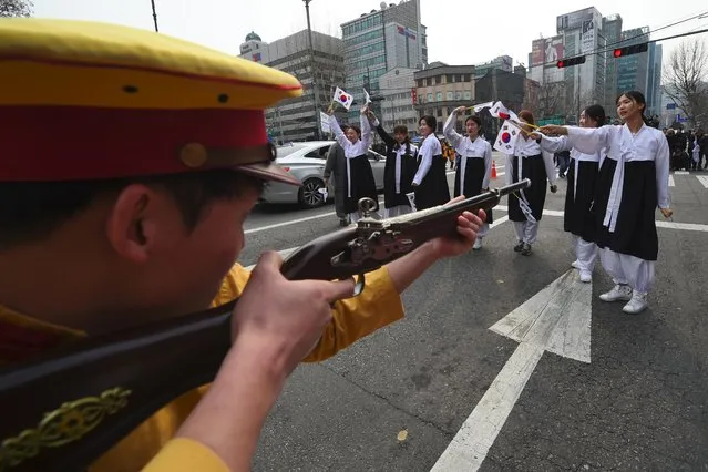 South Korean activists dressed as colonial-era Japanese soldiers reenact a crackdown of the independence movement during celebrations of the 98th Independence Movement Day in Seoul on March 1, 2017. South Korea on March 1 marked the anniversary of the country's 1919 uprising against the 1910-1945 Japanese colonial rule. (Photo by Jung Yeon-Je/AFP Photo)