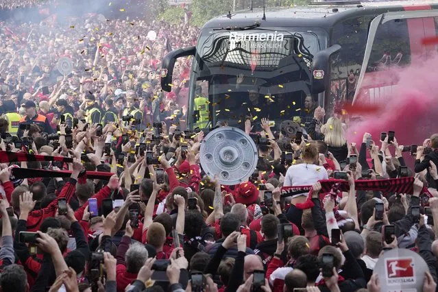 The team bus of Bayer Leverkusen is welcomed by thousands of supporters at the stadium ahead of the German Bundesliga soccer match between Bayer Leverkusen and Werder Bremen in Leverkusen, Germany, Sunday, April 14, 2024. Leverkusen could win the Bundesliga title if they win the match against Bremen. (Photo by Martin Meissner/AP Photo)