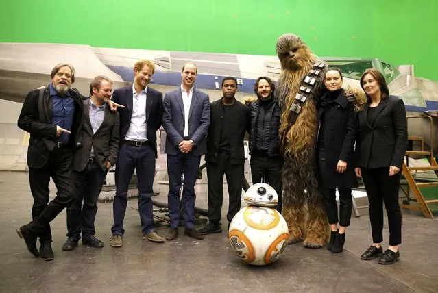 (L-R) US actor Mark Hamill, US director Rian Johnson, Britain's Prince Harry, Britain's Prince William, Duke of Cambridge, British actor John Boyega, Chewbacca and British actress Daisy Ridley pose during a tour of the Star Wars sets at Pinewood studios in Iver Heath, west of London, Britain on April 19, 2016. (Photo by Adrian Dennis/Reuters)