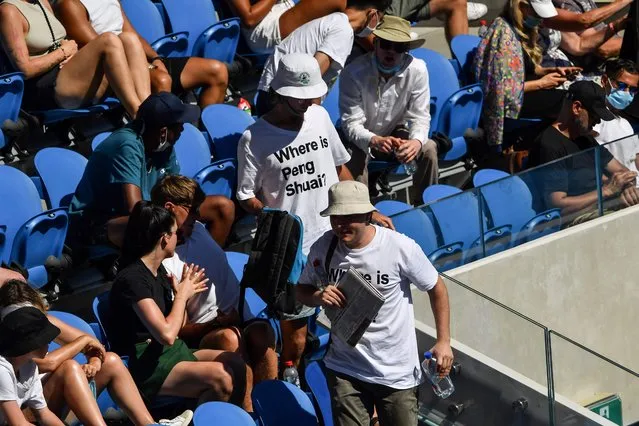 Two spectators wearing “Where is Peng Shuai?” T-shirts, referring to the former doubles world number one from China, are pictured in the stands on day nine of the Australian Open tennis tournament in Melbourne on January 25, 2022. (Photo by Paul Crock/AFP Photo)