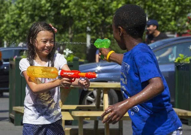 Children take part in a giant water fight on a hot summer day  in central Brussels, Belgium, July 3, 2015. (Photo by Yves Herman/Reuters)