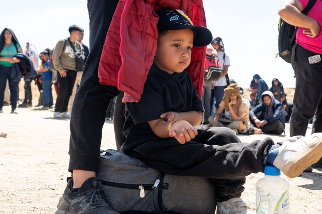 Matias, 4, an asylum-seeking migrant from Colombia waits with his mother to be transported at a staging area, after U.S. President Joe Biden announced a sweeping border security enforcement effort, in Jacumba Hot Springs, California on June 10, 2024. (Photo by Go Nakamura/Reuters)