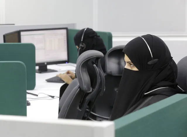 Saudi women receive calls at the National Center for Security Operations, days before the annual hajj pilgrimage, Wednesday, July 14, 2021, in the Muslim holy city of Mecca, Saudi Arabia. The pilgrimage to Mecca required once in a lifetime of every Muslim who can afford it and is physically able to make it, used to draw more than 2 million people. But for a second straight year it has been curtailed due to the coronavirus with only vaccinated people in Saudi Arabia able to participate. (Photo by Amr Nabil/AP Photo)