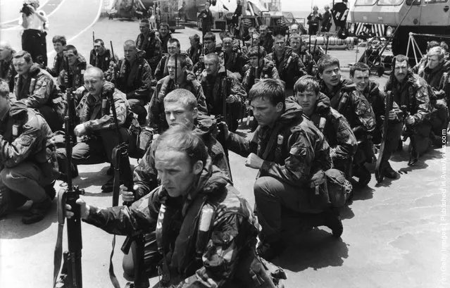 Royal Marines waiting on the flight deck of HMS Hermes for Sea King helicopters to take them on training manoeuvres, April 1982