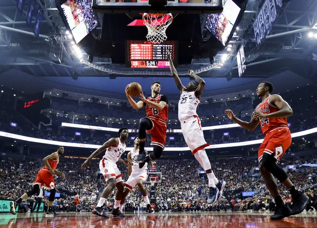 Zach LaVine #8 of the Chicago Bulls goes to the basket against Chris Boucher #25 of the Toronto Raptors during their NBA basketball pre-season game at Scotiabank Arena on October 13, 2019 in Toronto, Canada. (Photo by Mark Blinch/Getty Images)