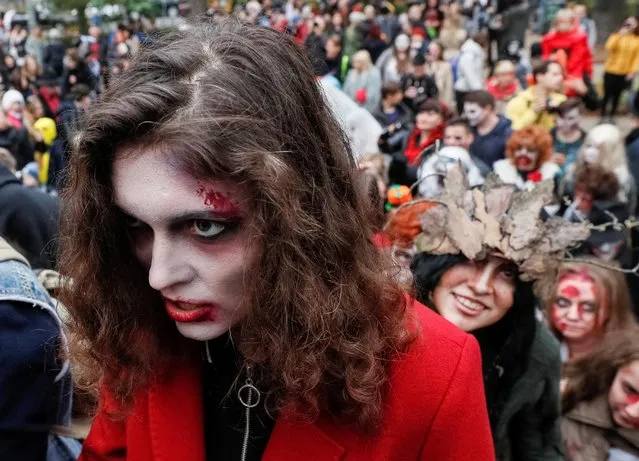 Participants dressed as zombies take part in a “Zombie Walk” parade to celebrate upcoming Halloween in Kiev, Ukraine on October 26, 2019. (Photo by Gleb Garanich/Reuters)