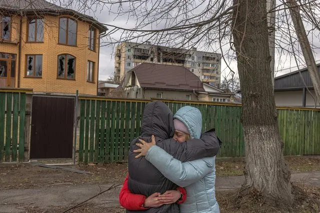 Vladyslava Liubarets (R), a Bucha resident, cries as she hugs her sister whom she did not see since the beginning of the Russian invasion, in Bucha, the town which was retaken by the Ukrainian army, northwest of Kyiv, Ukraine, 06 April 2022. Hundreds of tortured and killed civilians have been found in Bucha and other parts of the Kyiv region after the Russian army retreated from those areas. Russian troops entered Ukraine on 24 February resulting in fighting and destruction in the country, and triggering a series of severe economic sanctions on Russia by Western countries. (Photo by Roman Pilipey/EPA/EFE)