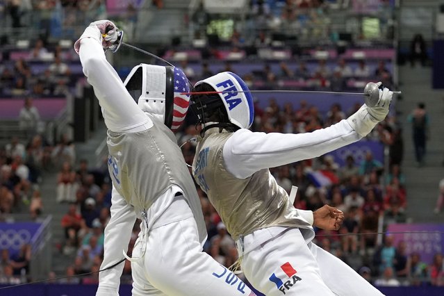 United State's Gerek Meinhardt, left, and France's Enzo Lefort compete in the men's individual Foil round of 16 competition during the 2024 Summer Olympics at the Grand Palais, Monday, July 29, 2024, in Paris, France. (Photo by Andrew Medichini/AP Photo)