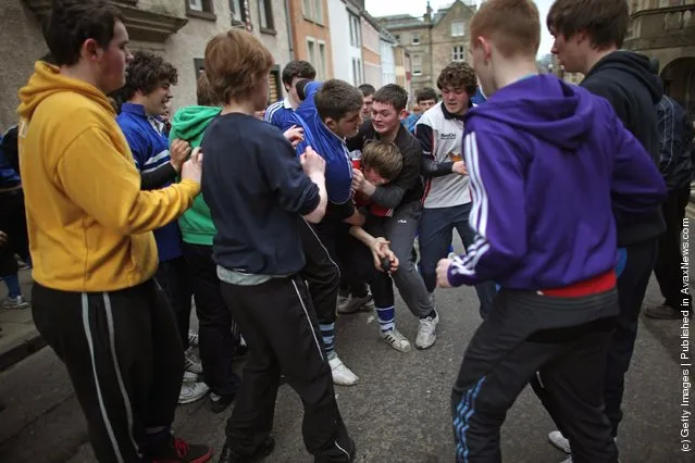 Youths tussle for the leather ball during the annual 'Fastern Eve Handba' event in Jedburgh's High Street in the Scottish Borders in Jedburgh