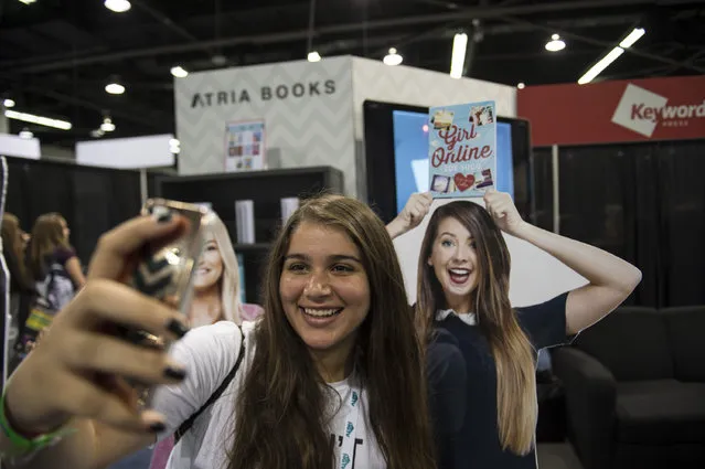 Anahid Mirhosseini, 16, takes a selfie with a life size photo of YouTube personality Zoe Sugg during the 6th annual VidCon at Anaheim Convention Center on Thursday, July 23, 2015, in Anaheim Calif. (Photo by Ed Crisostomo/The Orange County Register via AP Photo)