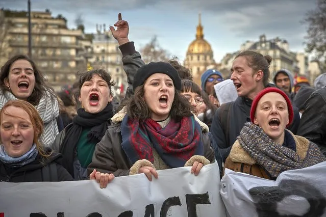 Protestors chant and sing songs against President Macron during a rally near Place des Invalides in Paris as thousands take to the streets to protest against pension reform on the sixth day of national strikes in France on December 10, 2019 in Paris, France. President Emmanuel Macron is facing his biggest test since the Gilet Jaune or “Yellow Vest” movement as railway, transportation workers, Teachers, students, hospital employees, police officers, garbage collectors, truck drivers and airline workers join the strike called in protest to changes to France’s pension system. (Photo by Kiran Ridley/Getty Images)