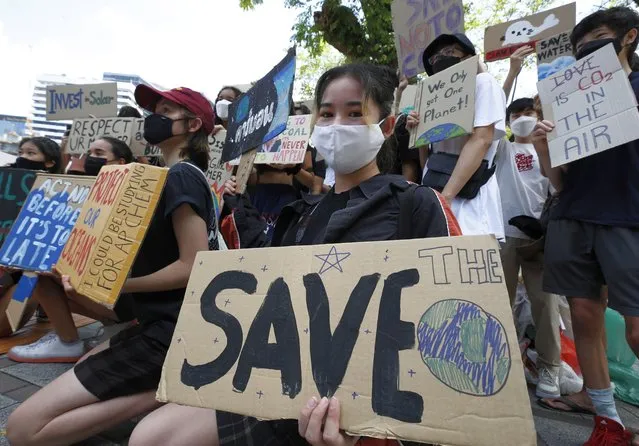 Activists hold signs during a climate change strike in Bangkok, Thailand, 22 April 2022. People are protesting to mark Earth Day and to demand that the Ministry of Natural Resources changes the way the climate crisis is handled in Thailand to safeguard the planet and the earth's environment. (Photo by Narong Sangnak/EPA/EFE)