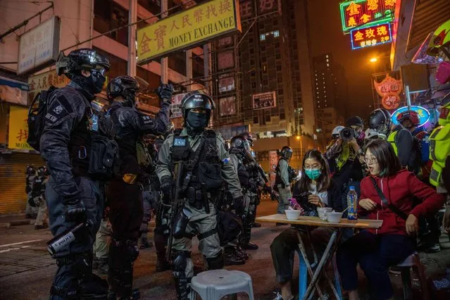 Riot police confront customers at a street food store during anti-government demonstrations in Hong Kong on Christmas Eve December 24, 2019. (Photo by Geovien So/Sopa Images/Zuma Wire/Alamy Live News)