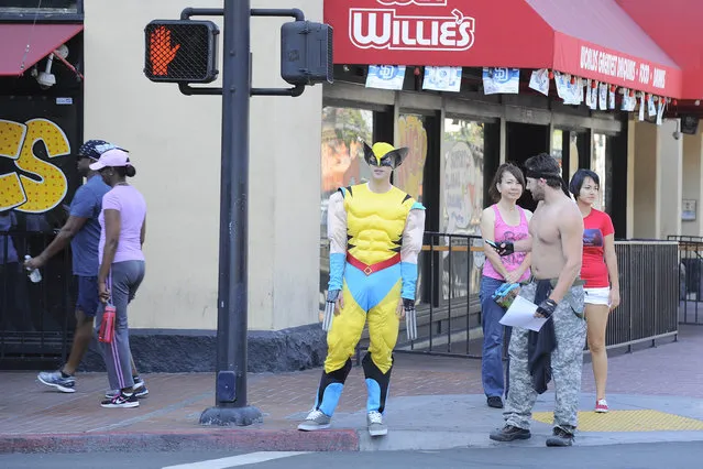 A fan dressed as Wolverine from the X-Men waits at a crosswalk on day 1 of the 2014 Comic-Con International Convention held Thursday, July 24, 2014 in San Diego. (Photo by Denis Poroy/Invision/AP Photo)