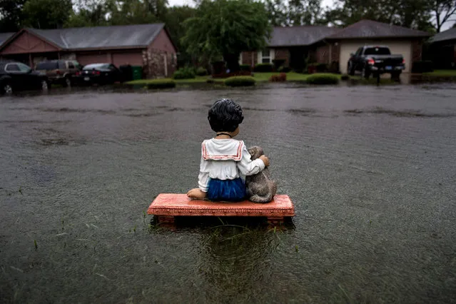 A lawn ornament is seen on a flooded street during the aftermath of Hurricane Harvey August 29, 2017 in Houston, Texas. Harvey has set what forecasters believe is a new rainfall record for the continental US, officials said Tuesday. Harvey, swirling for the past few days off Texas and Louisiana has dumped more than 49 inches (124.5 centimeters) of rain on the region. (Photo by Brendan Smialowski/AFP Photo)