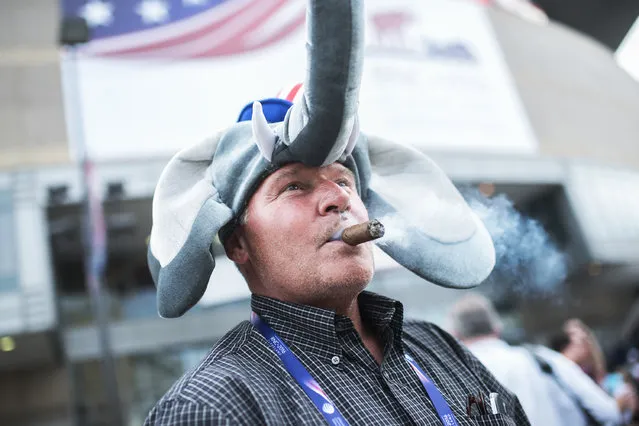 Delaware delegate Hank McCann smokes a cigar outside of the Quicken Loans Arena on first day of the Republican National Convention in Cleveland, Ohio, July 18, 2016. (Photo By Tom Williams/CQ Roll Call)