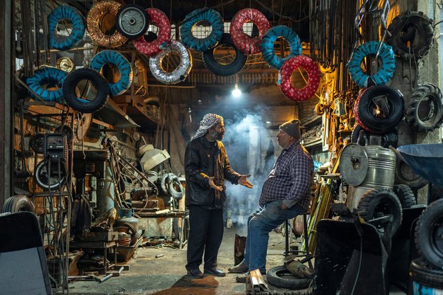 Workers at a tyre shop wait for customers on December 30, 2024 in Douma, on the outskirts of Damascus in Syria, which is acclimatising to life after the Assad regime. (Photo by Mosa’ab Elshamy/AP Photo)