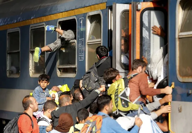 Migrants storm into a train at the Keleti train station in Budapest, Hungary, September 3, 2015 as Hungarian police withdrew from the gates after two days of blocking their entry. (Photo by Laszlo Balogh/Reuters)