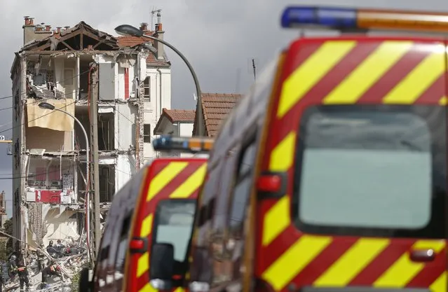 French firefighters search the rubble of a collapsed building in Rosny-Sous-Bois, near Paris August 31, 2014. A four-story building was rocked by an explosion and collapsed, killing a child, in a northeastern suburb of Paris on Sunday morning, French authorities said. Ten people, including four seriously wounded, were evacuated from the rubble of the building, and a child was killed, fire department spokesman Gabriel Plus told iTele. (Photo by Christian Hartmann/Reuters)