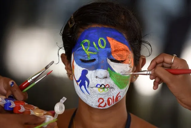 An Indian college student, has her face painted with emblem of the Rio 2016 Summer Olympics, in Chennai on August 4, 2016, in an event to wish the Indian contingent good luck ahead of the Rio 2016 Summer Olympics which is scheduled to begin on August 5, 2016. (Photo by Arun Sankar/AFP Photo)