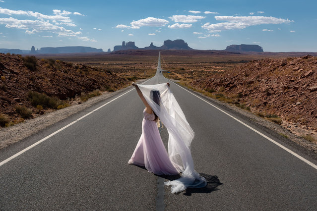 A tourist poses for wedding photos on October 11, 2024 in Monument Valley, Arizona. (Photo by Qian Weizhong/VCG via Getty Images)