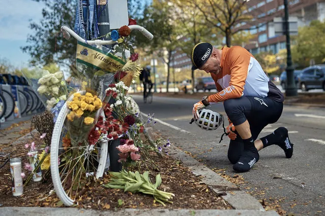 Eric Fleming, 41, stops by to express his condolences in front of a bike memorial where people leave flowers to remember the victims of the attack on Thursday, November 2, 2017, in New York. (Photo by Andres Kudacki/AP Photo)