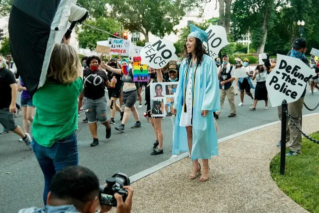 Protesters cheer for high school graduate Leah Powell during a march against racial inequality in the aftermath of the death in Minneapolis police custody of George Floyd, at the Lincoln Memorial in Washington, U.S., June 10, 2020. (Photo by Erin Scott/Reuters)