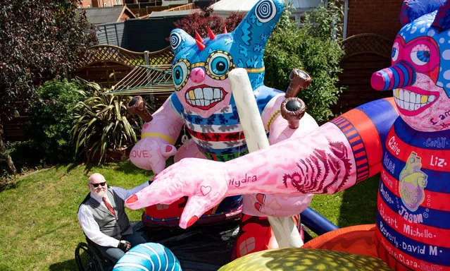 Disabled artist Jason Wilsher-Mills, who had been due to show his work at the Tate after winning the equivalent of the Turner Prize for disabled artists, has found new ways to work while self-isolating during the coronavirus pandemic by putting his giant inflatable sculptures on display in the back garden of his home in Sleaford, Lincolnshire, UK on June 22, 2020. (Photo by Jacob King/PA Images via Getty Images)