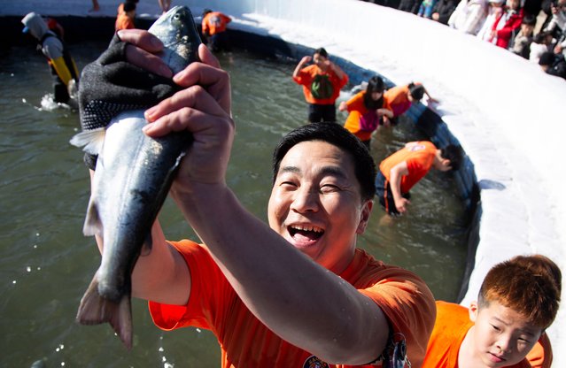 Visitors cheer as they bare-hand fish in a frozen river during the Hwacheon Sancheoneo Ice Festival at Hwacheon-gun in Gangwon province, South Korea, 06 January 2024. The festival runs under the slogan “Unfrozen Hearts, Unforgettable Memories” from 06 to 28 January 2024. (Photo by Jeon Heon-Kyun/EPA/EFE)