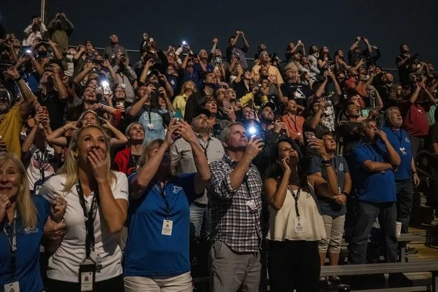 In this photo provided by NASA, guests at the Banana Creek watch the launch of NASA's Space Launch System rocket carrying the Orion spacecraft on the Artemis I flight test, early Wednesday, November 16, 2022, at NASA's Kennedy Space Center in Fla. (Photo by Keegan Barber/NASA via AP Photo)