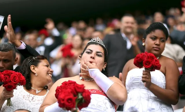 A bride reacts during a mass wedding ceremony at Arena Corinthians soccer stadium in Sao Paulo, Brazil, September 26, 2015. (Photo by Paulo Whitaker/Reuters)