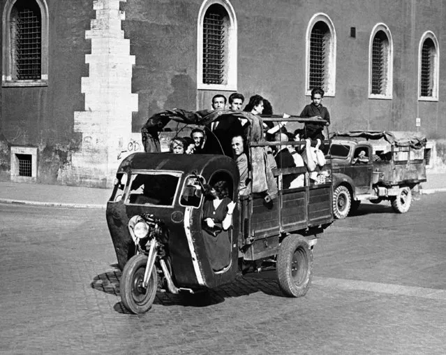 The famous Seven Hills of Rome, present citizens of the Italian capital with a serious problem of transportation. The Germans looted most of Rome's motor buses, and the taxis have been requisitioned by the Allied commission leaving only a few trolley-buses and street cars which do not connect all parts of the city. Many strange contrivances are therefore to be seen running the streets, helping to convey Romans from place to place in the capital. The three wheel truckbed vehicle is called “motofurgoncino” and carries passengers who stand and sit in the back, in Rome on October 11, 1945. During rush hours two passengers, one on either side, ride with the driver. (Photo by AP Photo)