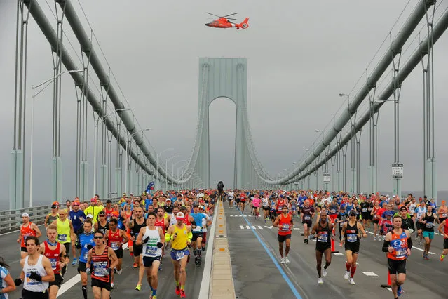The first wave of runners makes their way across the Verrazano-Narrows Bridge during the start of the New York City Marathon in New York, U.S., November 5, 2017. (Photo by Lucas Jackson/Reuters)
