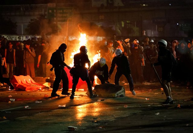 A fire burns as demonstrators take part in a protest outside the Indonesian Parliament against revisions to the country's military law, which will allocate more civilian posts for military officers, in Jakarta, Indonesia on March 27, 2025. (Photo by Ajeng Dinar Ulfiana/Reuters)