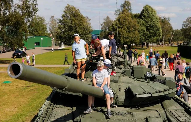 Children play atop of T-72 tank which is on display during the International military-technical forum “Army-2020” at Alabino range in Moscow Region, Russia, August 23, 2020. (Photo by Maxim Shemetov/Reuters)