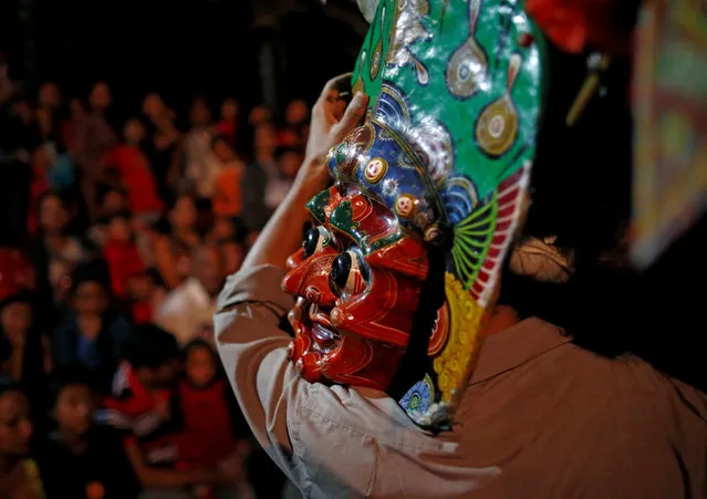 A man carries a mask of a deity after a traditional mask dance during the Indra Jatra festival in Kathmandu, Nepal September 13, 2016. (Photo by Navesh Chitrakar/Reuters)