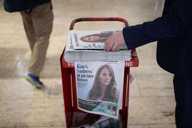 A commuter picks up a copy of the Evening Standard, featuring a cover story on Catherine, the Princess of Wales, at a subway station in London on Tuesday, March 12, 2024. This was after several major news agencies had withdrawn a photo distributed by Kensington Palace showing Catherine and her children, saying they believed the photo had been manipulated. In a statement, Catherine acknowledged that she used an editing tool or tools to alter the image. (Photo by Hollie Adams/Reuters)