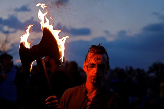 A performer holds an axe on fire at the Bealtaine fire festival, marking the beginning of summer at the Hill of Uisneach in Rathnew, Ireland, on May 10, 2025. (Photo by Clodagh Kilcoyne/Reuters)