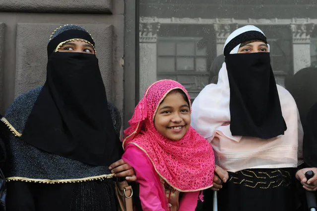 Two women and a girl wearing Muslim headscarves pose for a photo before the start of the annual Muslim Day Parade in the Manhattan borough of New York City, September 25, 2016. (Photo by Stephanie Keith/Reuters)